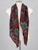 Large square paisley wool scarf styled as shawl over mannequin shoulders