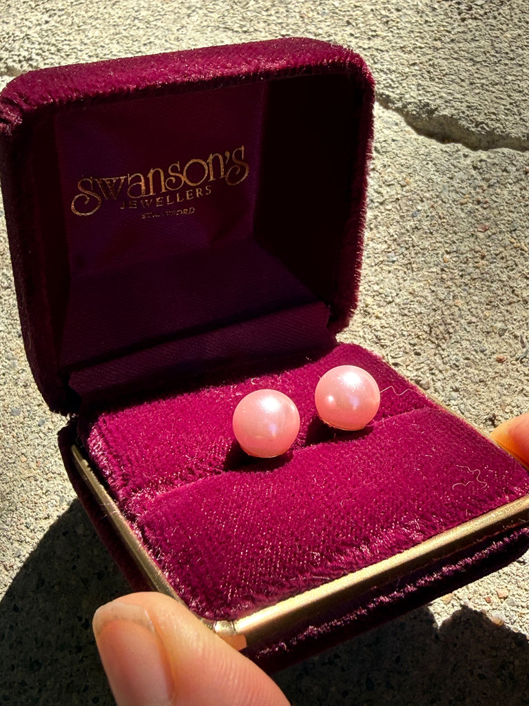 Close-up of vintage pink faux pearl stud earrings in burgundy jewellery box