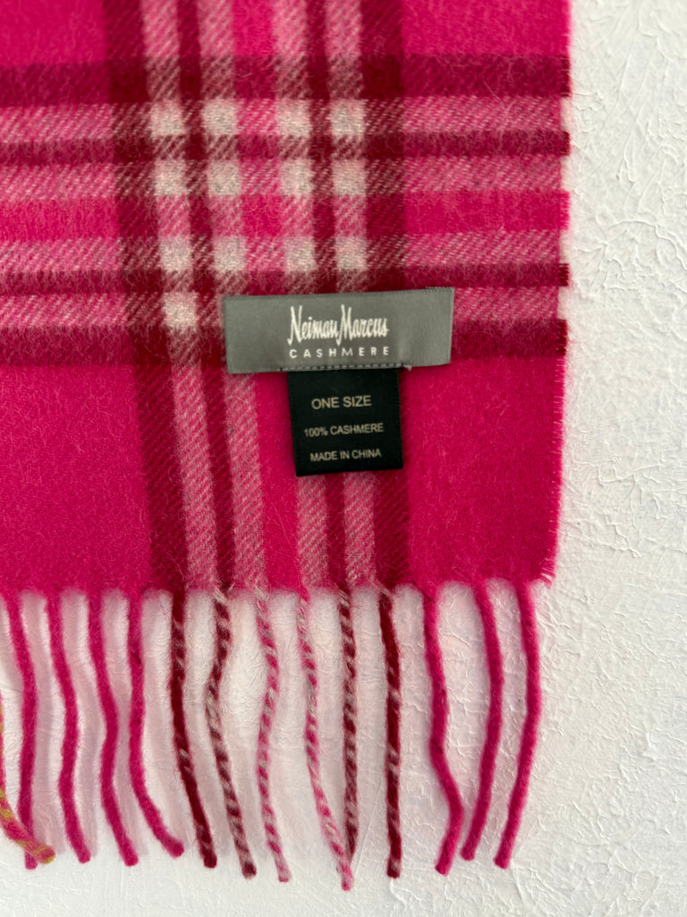 Close-up of fuchsia pink plaid cashmere scarf showing designer label and fringe