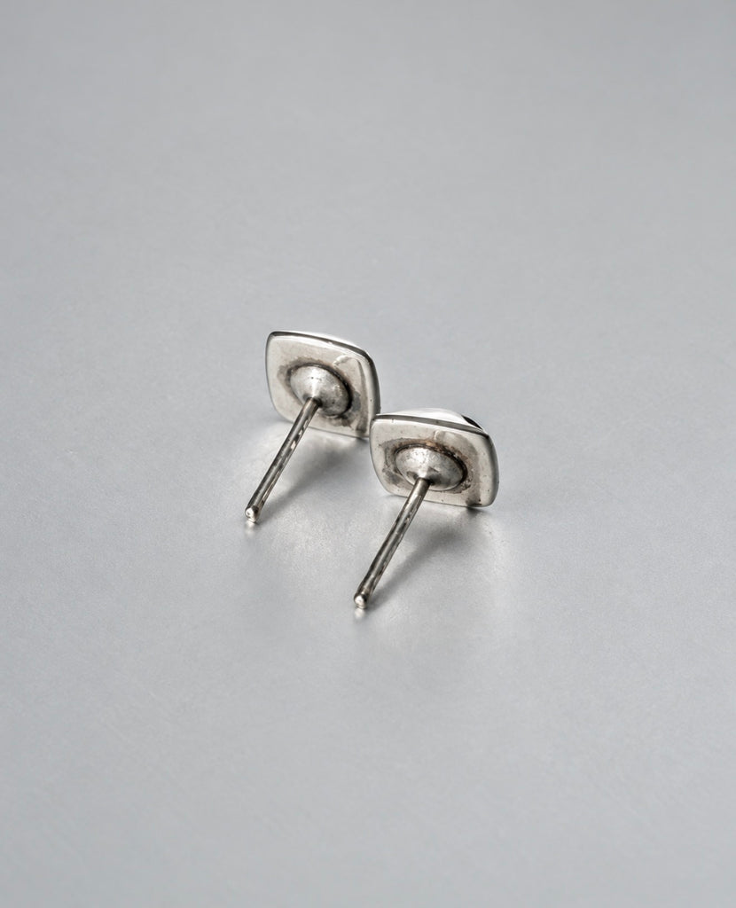 Back of vintage silver stud earrings showing posts and butterfly backs