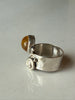 Side profile of Baltic amber sterling silver ring showing raised amber cabochon