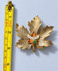 Montreal maple leaf enamel brooch shown beside measuring tape for size