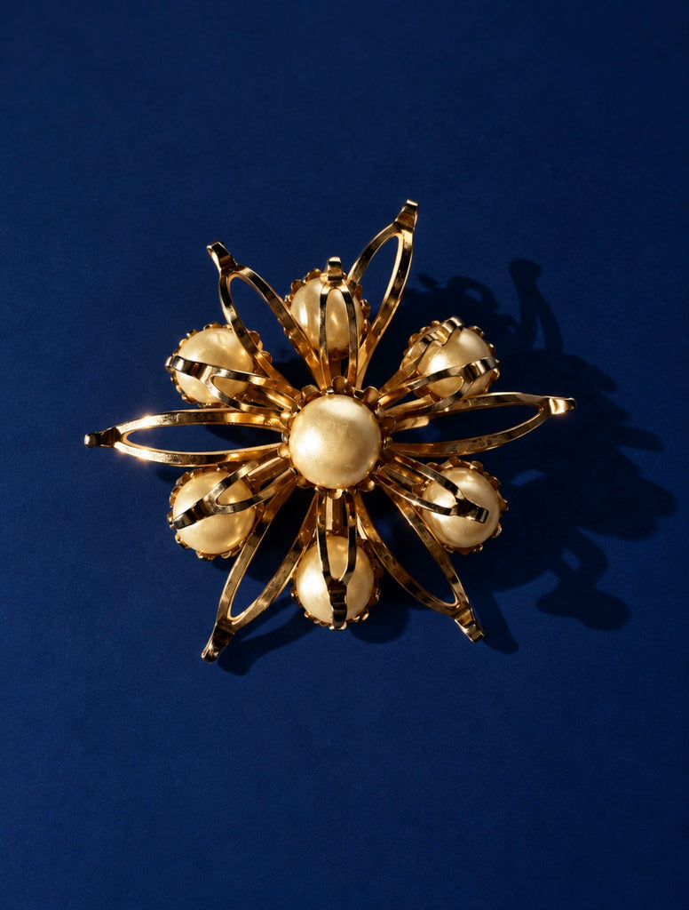 Vintage floral brooch with cream faux pearls and dimensional gold-tone petals