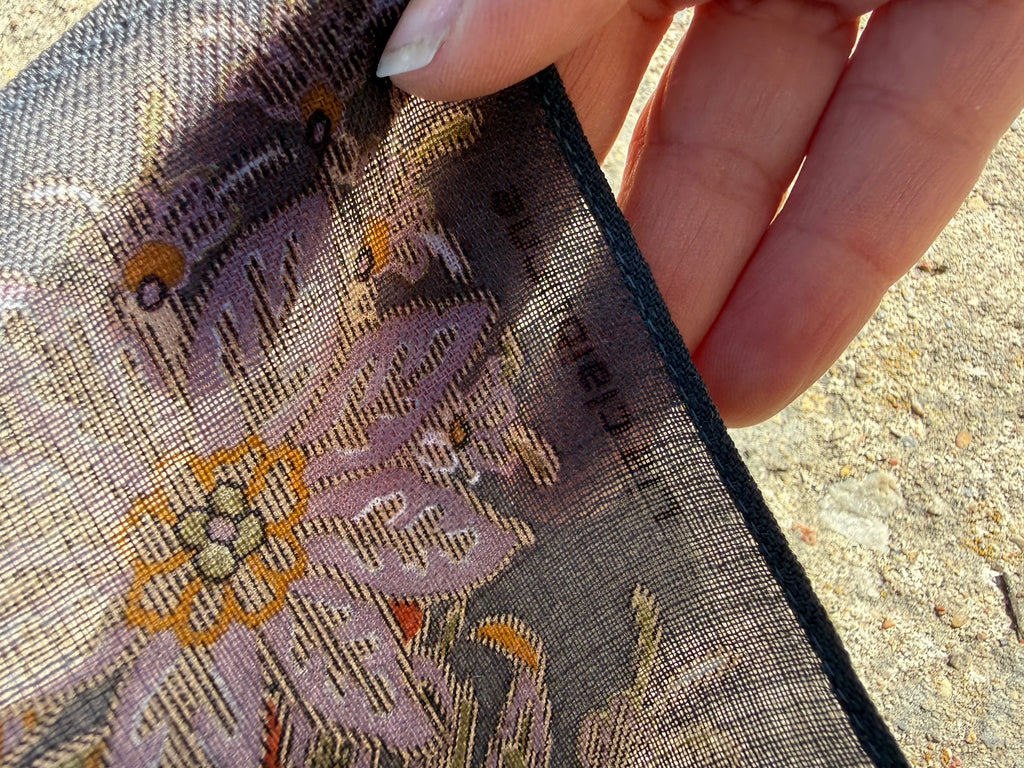 Close-up of wool scarf fabric and colourful printed floral design