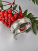 Ladye Fayre sterling silver hinged bracelet displayed with red berries