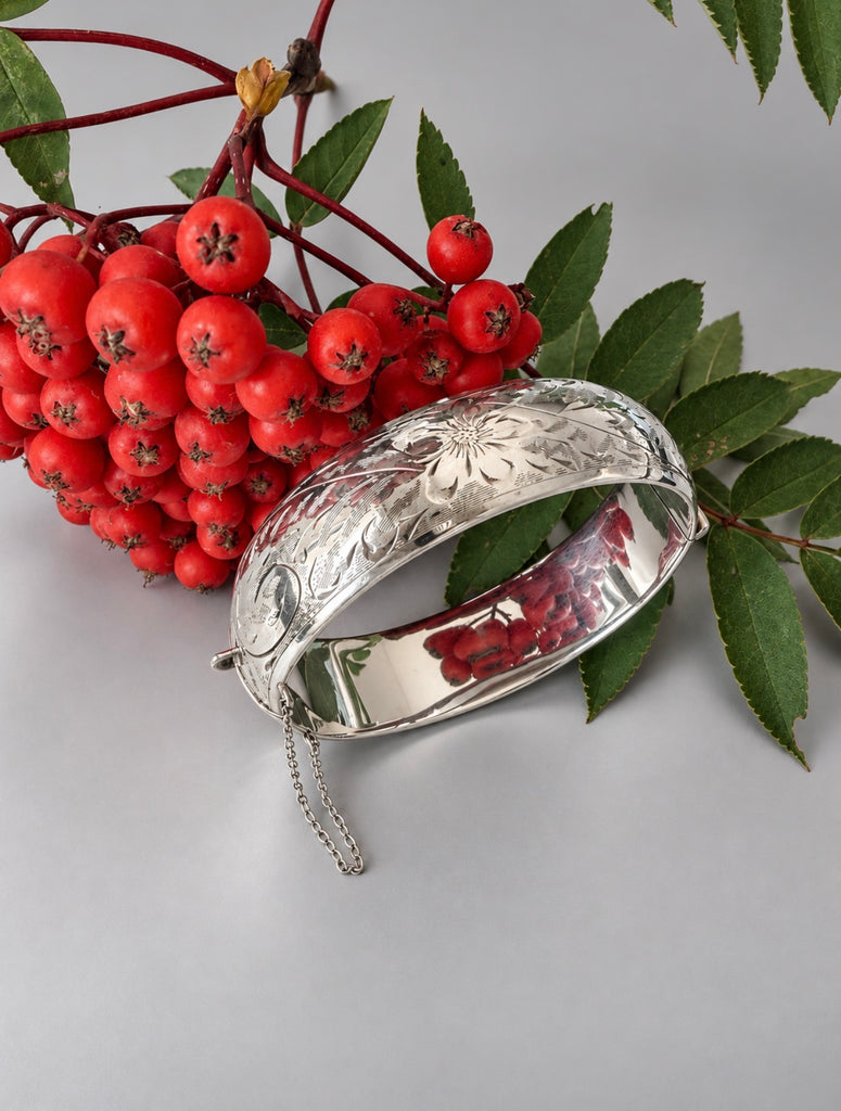 Ladye Fayre sterling silver hinged bracelet displayed with red berries