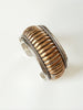 Close-up of vintage two-tone sterling silver cuff bracelet with ribbed design