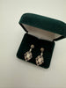 Vintage black and silver drop earrings with articulated ornate openwork design