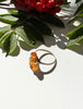Side view of vintage Baltic amber ring with open sterling silver setting