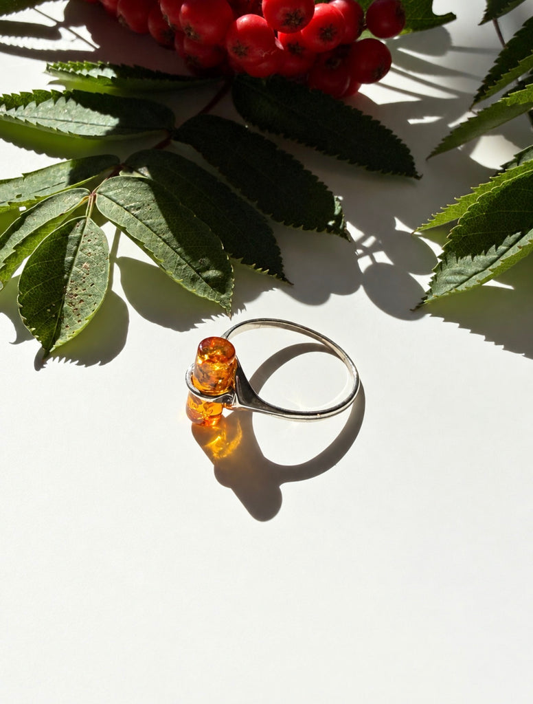 Side view of vintage Baltic amber ring with open sterling silver setting