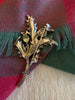 Back view of vintage Scottish thistle brooch showing silver-tone metal and locking pin back