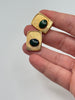 Vintage oval green cabochon cufflinks with textured gold-tone settings shown for scale