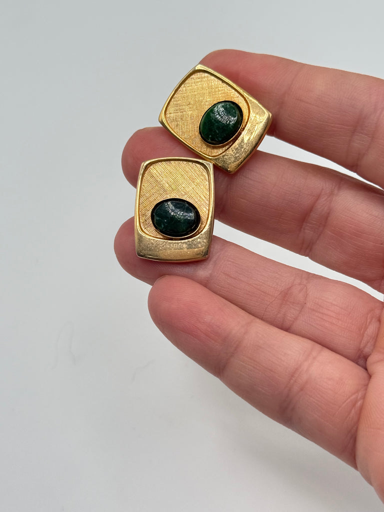 Vintage oval green cabochon cufflinks with textured gold-tone settings shown for scale