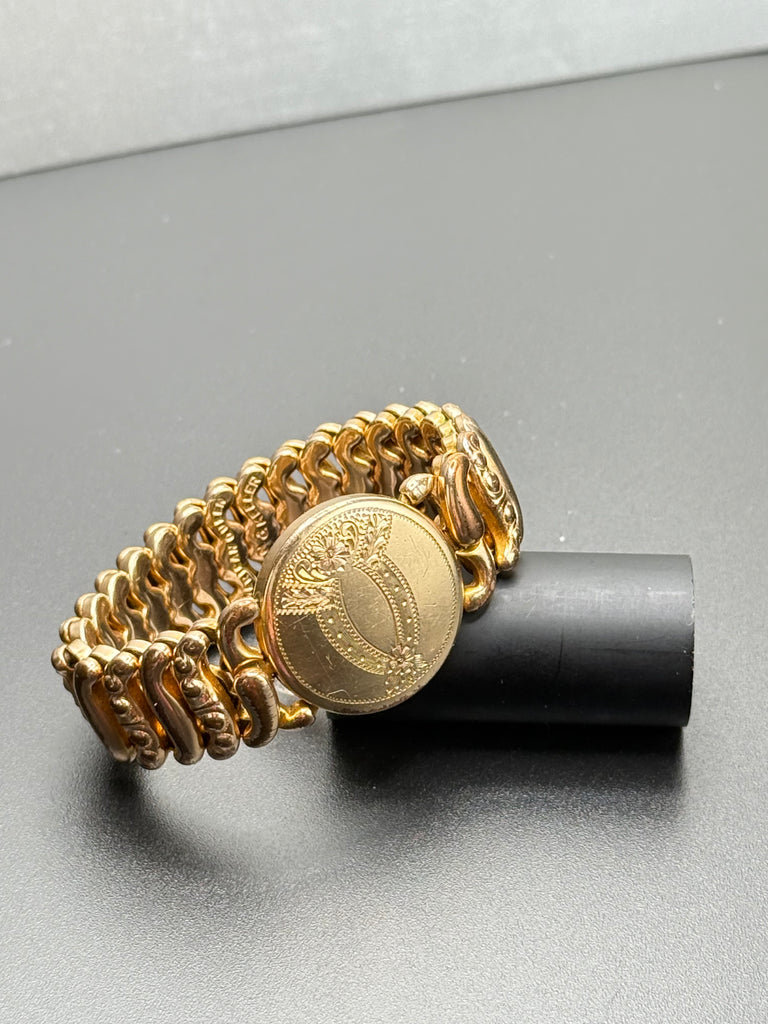 Antique American Queen gold-filled sweetheart expansion bracelet by Pitman & Keeler with engraved floral medallion and ornate S-scroll links. 