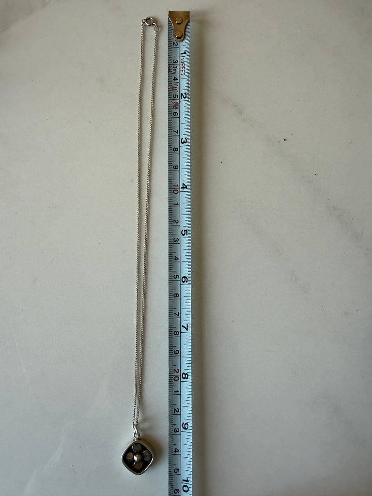 Vintage Finnish pendant necklace beside measuring tape showing chain length