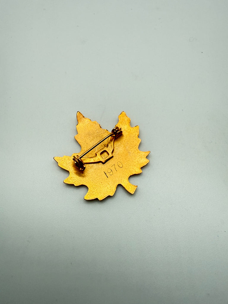 Back of vintage Canadian maple leaf brooch showing pin closure and engraved 1970 date