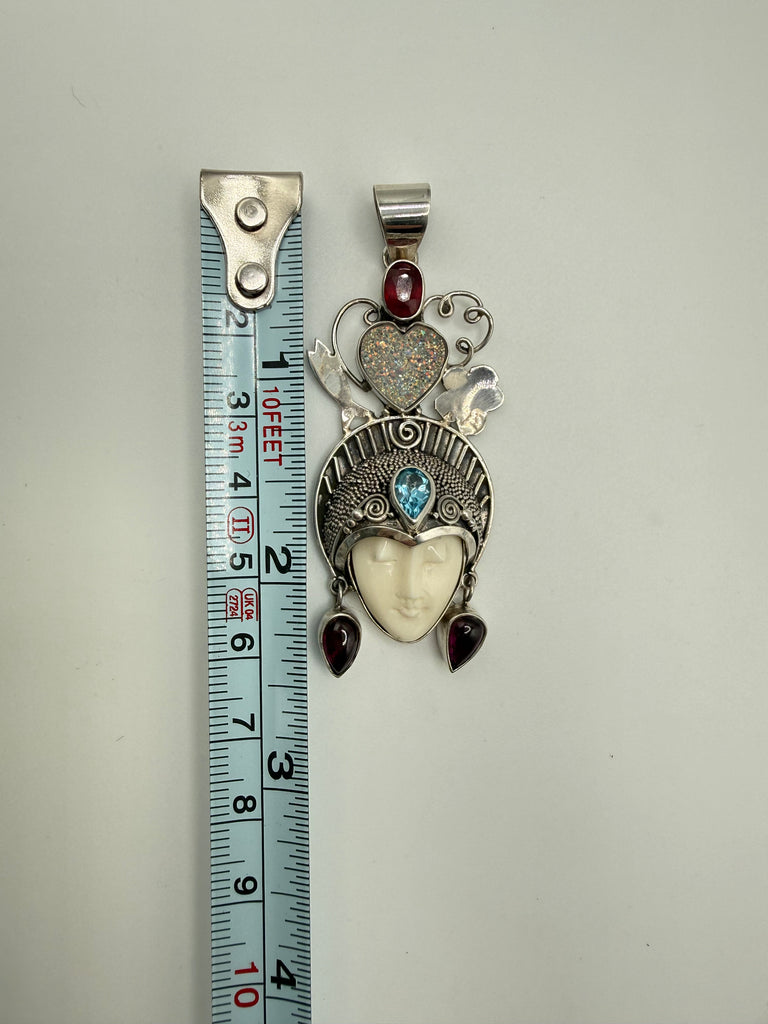 Vintage Queen of Hearts goddess pendant beside measuring tape showing approximately 2.5 inch length
