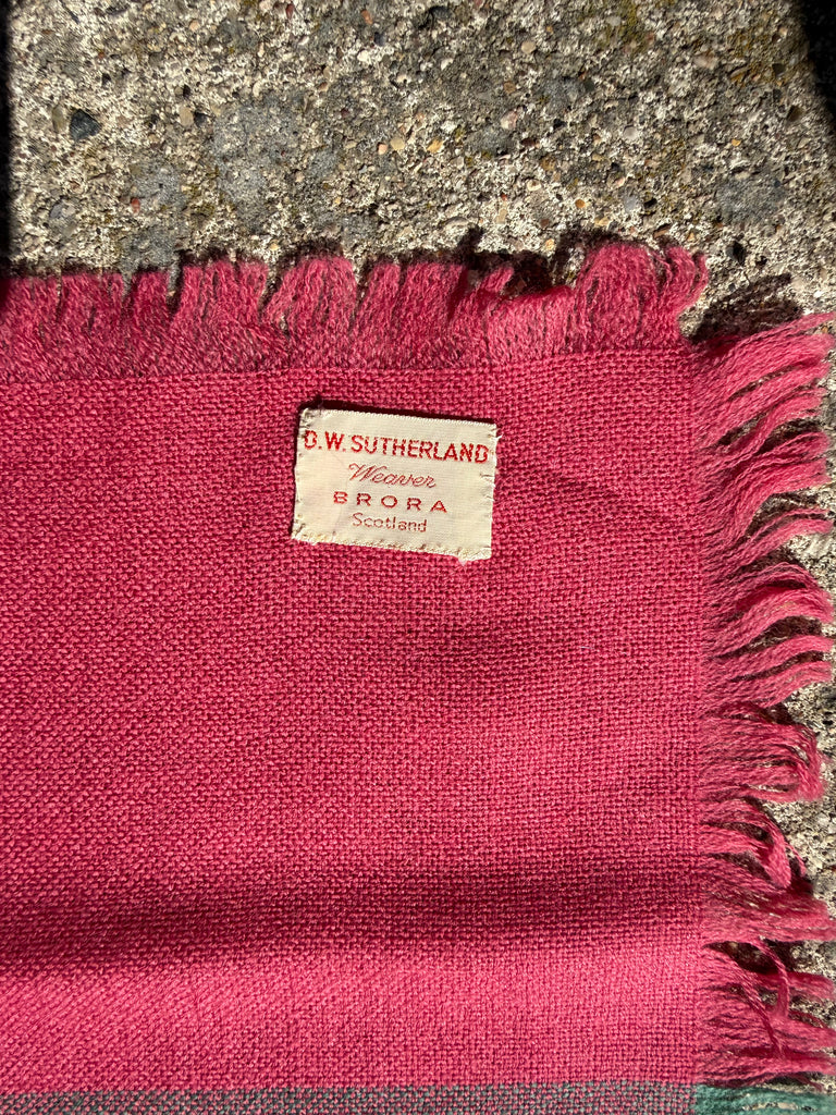 Close-up of vintage Scottish wool scarf showing original D.W. Sutherland maker's label