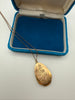 Vintage 1975 gold-filled engraved floral locket necklace displayed in blue jewellery box
