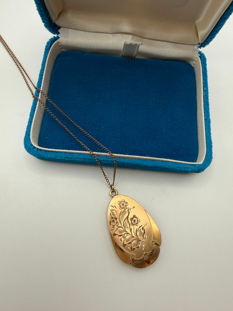 Vintage 1975 gold-filled engraved floral locket necklace displayed in blue jewellery box