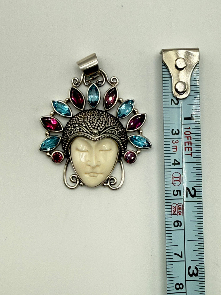 Vintage Balinese Moon Goddess silver pendant beside measuring tape showing pendant length