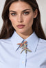 Gold-tone dragonfly brooch with pink and blue rhinestone wings shown worn on blouse