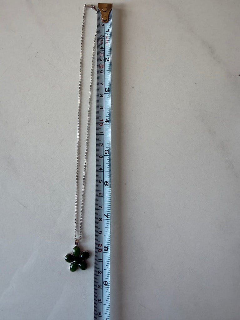 1. Sterling silver necklace chain shown beside measuring tape for length