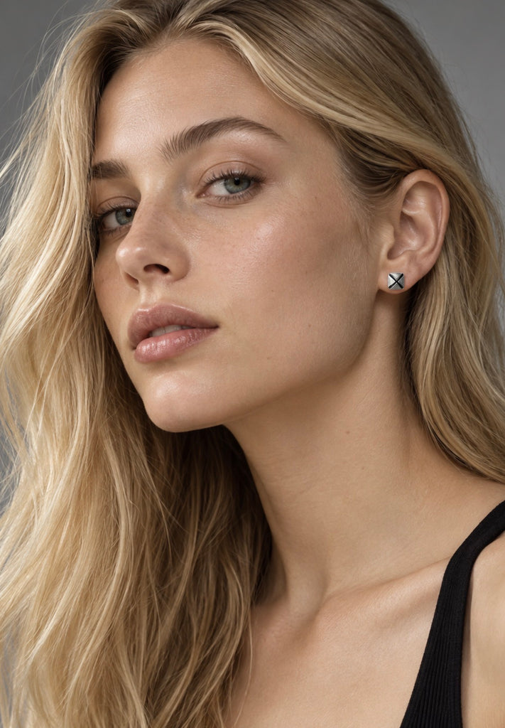 Small vintage geometric silver stud earrings shown worn on ear