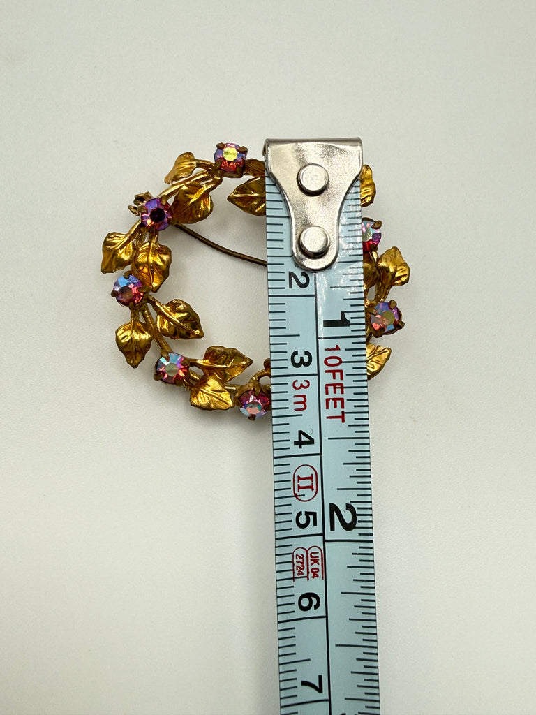 Austrian Aurora Borealis wreath brooch beside measuring tape showing approximately 4 cm across