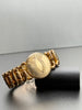 Close-up of vintage sweetheart bracelet showing unmonogrammed floral engraved centre medallion. 