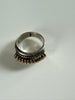 Vintage sterling silver ring showing dimensional ribbed design and gold-tone accents