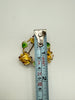 Yellow rose wreath brooch beside measuring tape showing approximately 4 cm across