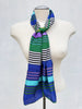 Vintage jewel tone striped scarf styled around the neck on mannequin. 