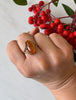 Vintage Polish amber ring worn on hand showing warm orange gemstone