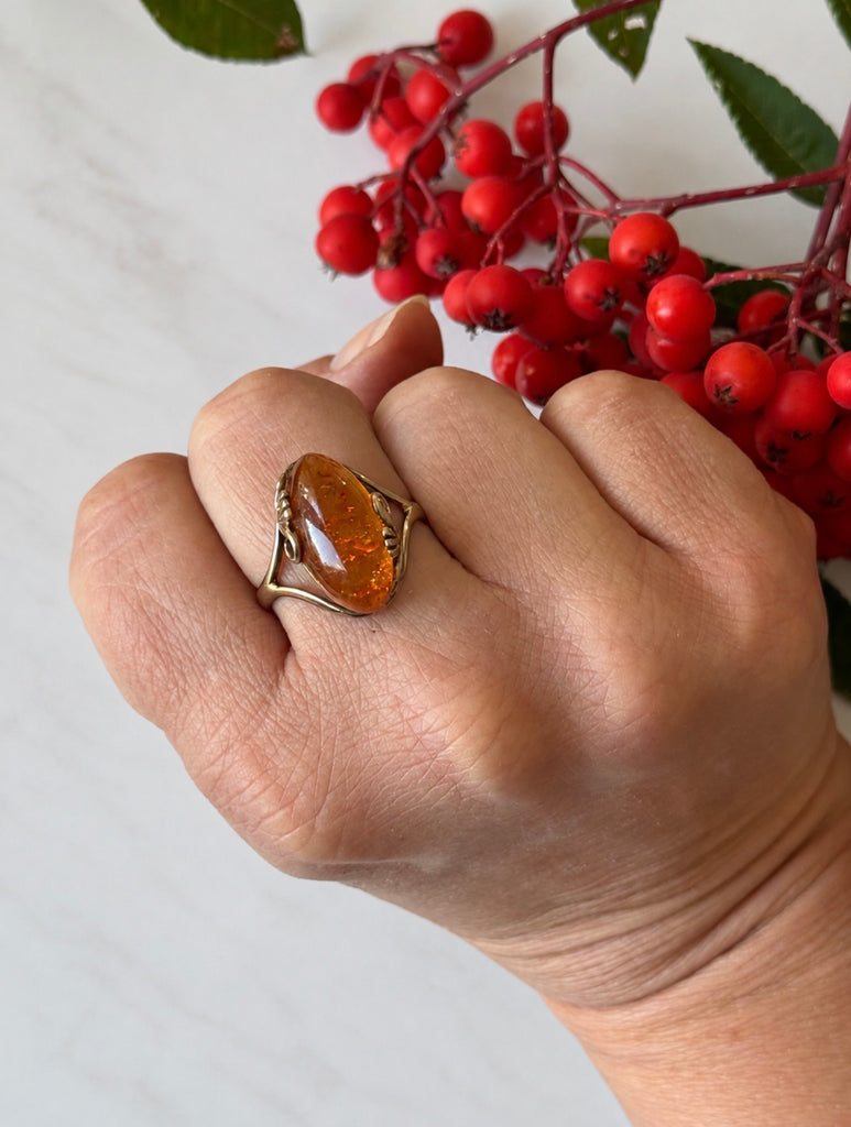 Vintage Polish amber ring worn on hand showing warm orange gemstone