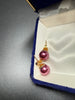 Pair of vintage raspberry pink faux pearl stud earrings displayed in blue jewellery box