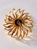 Back-view of vintage Sarah Coventry Amber Blossom rhinestone brooch showing rollover safety clasp
