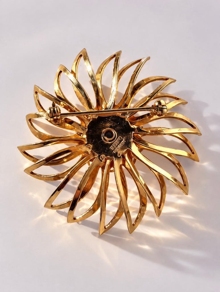 Back-view of vintage Sarah Coventry Amber Blossom rhinestone brooch showing rollover safety clasp
