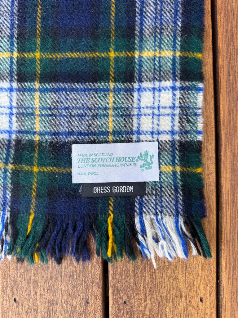 Close-up of The Scotch House vintage wool scarf label Made in Scotland. 