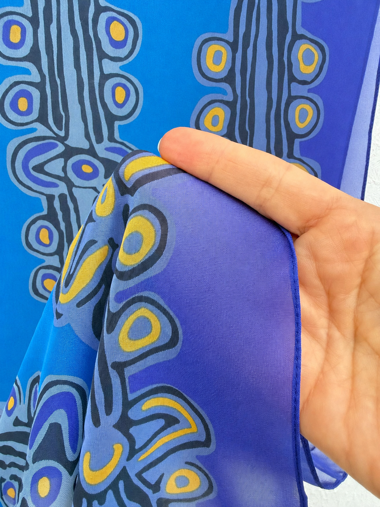 Close-up of Lily Nungarrayi Hargraves scarf showing blue yellow purple and black abstract design. 