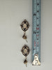 Vintage 925 silver drop earrings beside measuring tape showing approximately 1.25 inch length