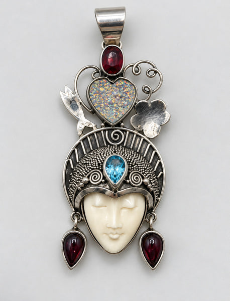 Vintage Queen of Hearts goddess sterling silver pendant with carved bone face, blue topaz and red garnet accents
