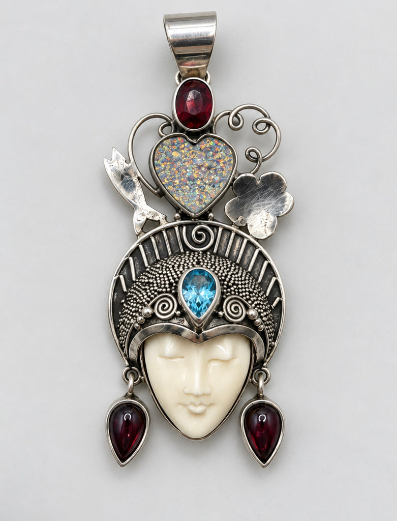 Vintage Queen of Hearts goddess sterling silver pendant with carved bone face, blue topaz and red garnet accents