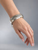 Vintage sterling silver floral bangle bracelet worn on wrist