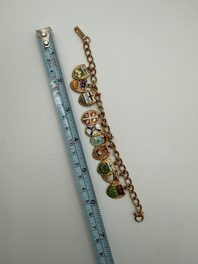 Vintage Canadian provincial charm bracelet shown beside measuring tape at approximately 7 inches long