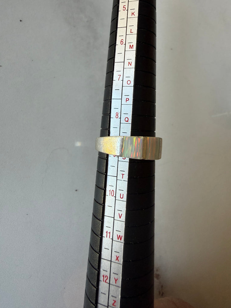 Sterling silver opal ring on ring sizing mandrel showing size 9