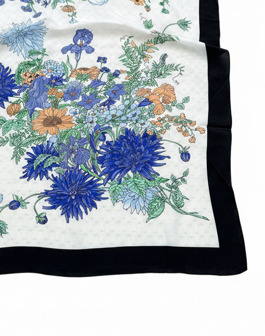Close-up of vintage Western wild rag showing floral print and black border. 