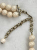 Heidi Daus necklace showing bronze tone chain extender hook closure and cream simulated pearl strands