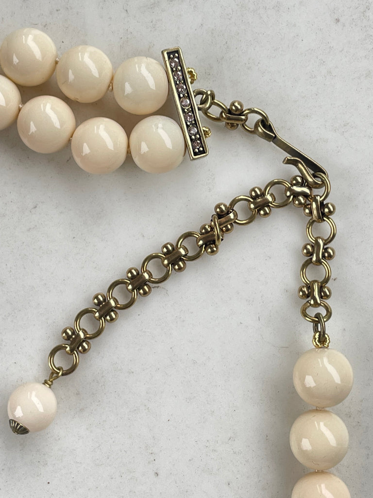 Heidi Daus necklace showing bronze tone chain extender hook closure and cream simulated pearl strands