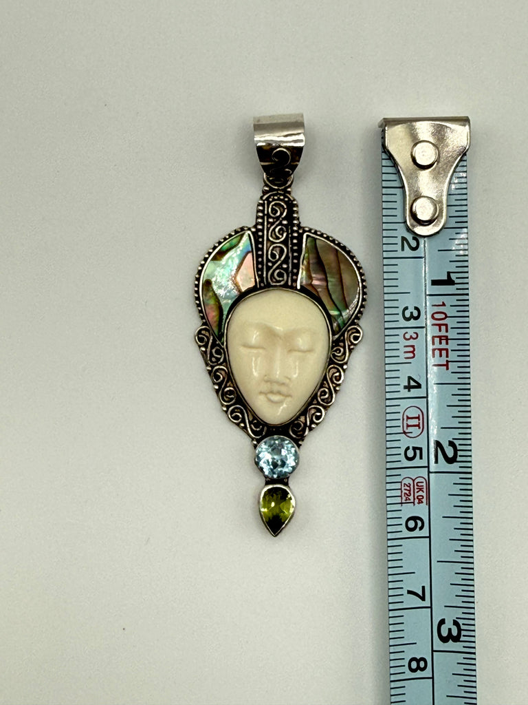 Vintage Bali silver pendant beside measuring tape showing approximately 2.25 inch length